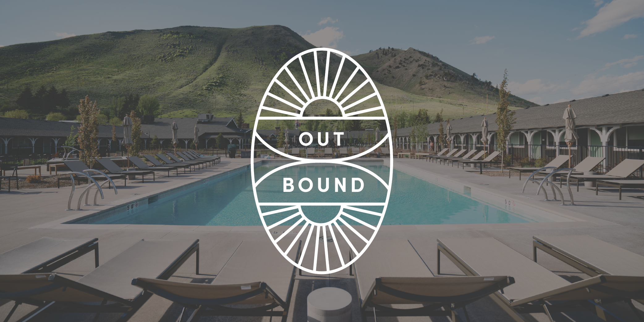 Outbound logo in front of a swimming pool and mountains